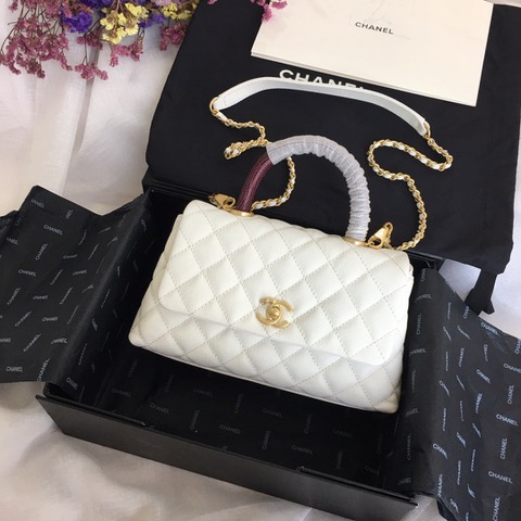 CHANEL Flap Bag with Coco Handle. Original Quality Bag including gift box, care book, dust bag, authenticity card. Despite the similarities to the Chanel Flap Bag, the Coco Handle stands apart from this and other popular Chanel models. And is perhaps the main reason behind it being unofficially renamed as the ‘Coco Handle’! The top ‘handle’ is its most distinctive feature. Structured and comfortably sized, it stands tall even when put down. The handle, combined with the trapezoid shape, bestows a modern touch to an otherwise classic style. Depending on the size you choose, the bag can find function as a day, an evening, or a day-to-night bag.