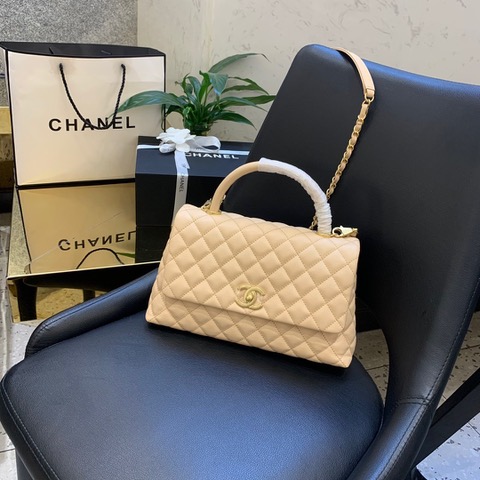 CHANEL Flap Bag with Coco Handle. Original Quality Bag including gift box, care book, dust bag, authenticity card. Despite the similarities to the Chanel Flap Bag, the Coco Handle stands apart from this and other popular Chanel models. And is perhaps the main reason behind it being unofficially renamed as the ‘Coco Handle’! The top ‘handle’ is its most distinctive feature. Structured and comfortably sized, it stands tall even when put down. The handle, combined with the trapezoid shape, bestows a modern touch to an otherwise classic style. Depending on the size you choose, the bag can find function as a day, an evening, or a day-to-night bag.