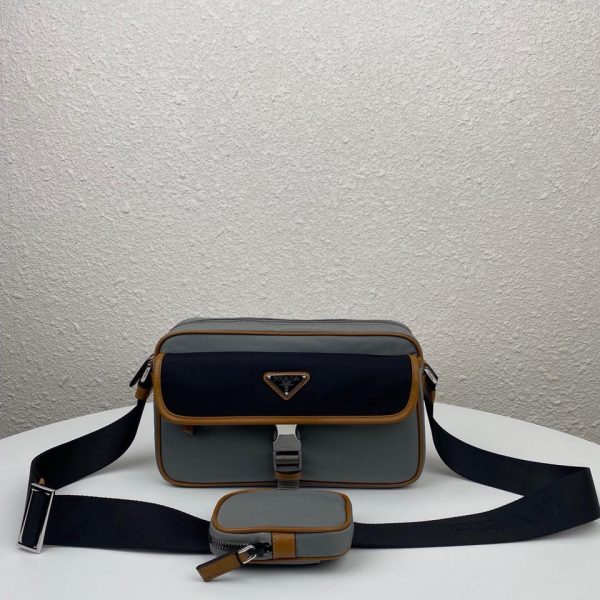 PRADA Nylon Cross-Body Bag. Original Quality Bag including gift box, care book, dust bag, authenticity card. This bag decorated with Saffiano leather trim presents compact volumes and a sleek design. With its distinctive side release buckle on the front, it comes with an easily adjustable shoulder strap. This cross-body bag featuring Saffiano leather trim with metal hardware and Prada logo lining, logo tag inside, enameled metal triangle logo outside. It has a main compartment with zipper, secondary compartment with flap and side release buckle, two front pockets, including one with zipper.