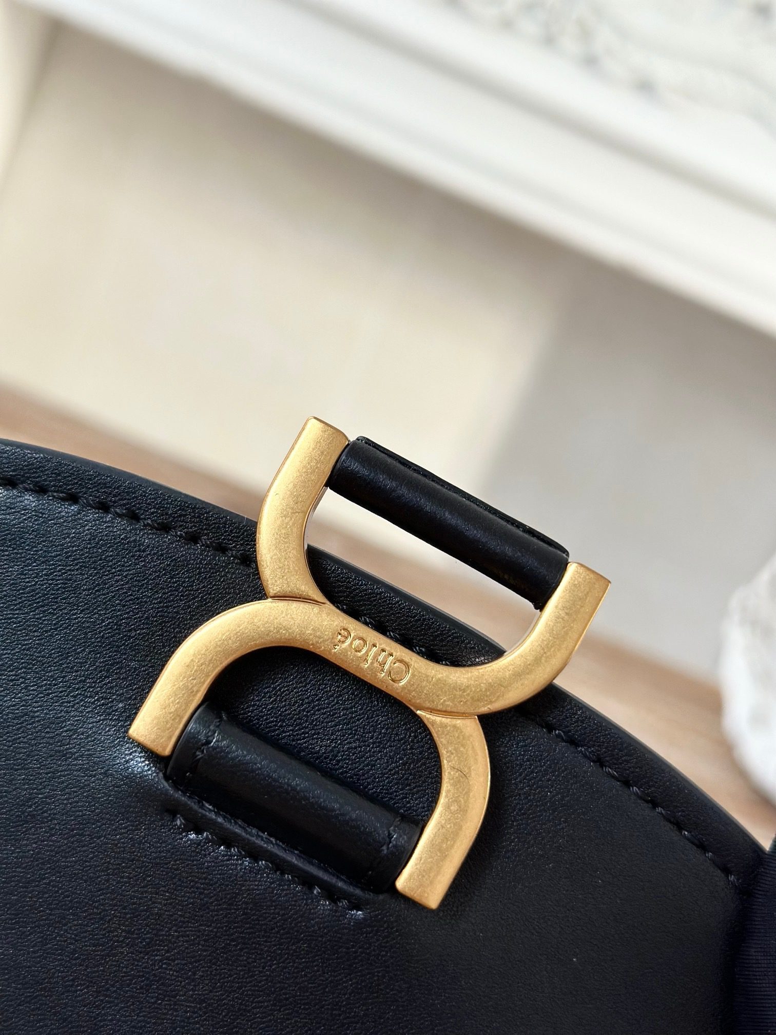 Marcie Chain Flap Bag. Authentic quality luxury bag crafted in genuine leather comes with authenticity card, dust bag and gift bag. Elevating Iconic Elegance: Marcie Line Redefined. Experience a fresh take on *loé's iconic Marcie line with this exquisite chain flap bag, meticulously crafted from a captivating blend of nappa lambskin, grained calfskin, and sumptuous suede. The line's signature hardware undergoes a graceful transformation, now adorned with *loé's engraved jewelry hallmark, adorning the flap with sophistication. An intricately hand-braided top handle pays homage to another hallmark Marcie feature, while a gracefully extended chain strap adds a refined touch. Whether you choose to drape it over your shoulder or wear it cross-body during the day, or opt to detach the strap and carry it by hand for a sophisticated evening ensemble, this flap bag is a versatile masterpiece. *loé's Marcie bag line effortlessly melds a feminine aesthetic with the free-spirited vibe of the '70s. An equestrian-inspired allure takes center stage, elevated by the allure of gleaming gold-toned hardware, resulting in a distinctly feminine yet timelessly chic look.