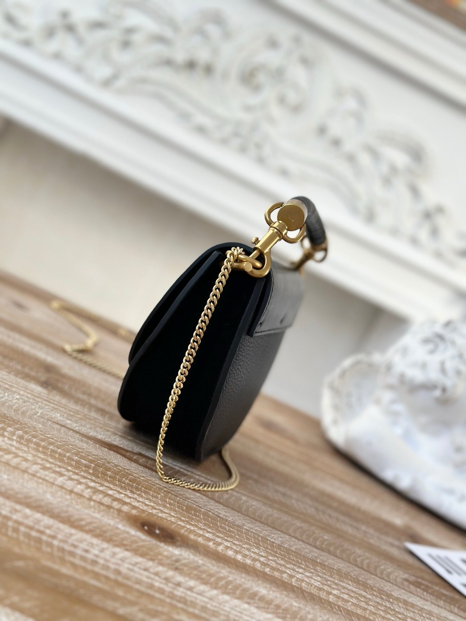 Marcie Chain Flap Bag. Authentic quality luxury bag crafted in genuine leather comes with authenticity card, dust bag and gift bag. Elevating Iconic Elegance: Marcie Line Redefined. Experience a fresh take on *loé's iconic Marcie line with this exquisite chain flap bag, meticulously crafted from a captivating blend of nappa lambskin, grained calfskin, and sumptuous suede. The line's signature hardware undergoes a graceful transformation, now adorned with *loé's engraved jewelry hallmark, adorning the flap with sophistication. An intricately hand-braided top handle pays homage to another hallmark Marcie feature, while a gracefully extended chain strap adds a refined touch. Whether you choose to drape it over your shoulder or wear it cross-body during the day, or opt to detach the strap and carry it by hand for a sophisticated evening ensemble, this flap bag is a versatile masterpiece. *loé's Marcie bag line effortlessly melds a feminine aesthetic with the free-spirited vibe of the '70s. An equestrian-inspired allure takes center stage, elevated by the allure of gleaming gold-toned hardware, resulting in a distinctly feminine yet timelessly chic look.