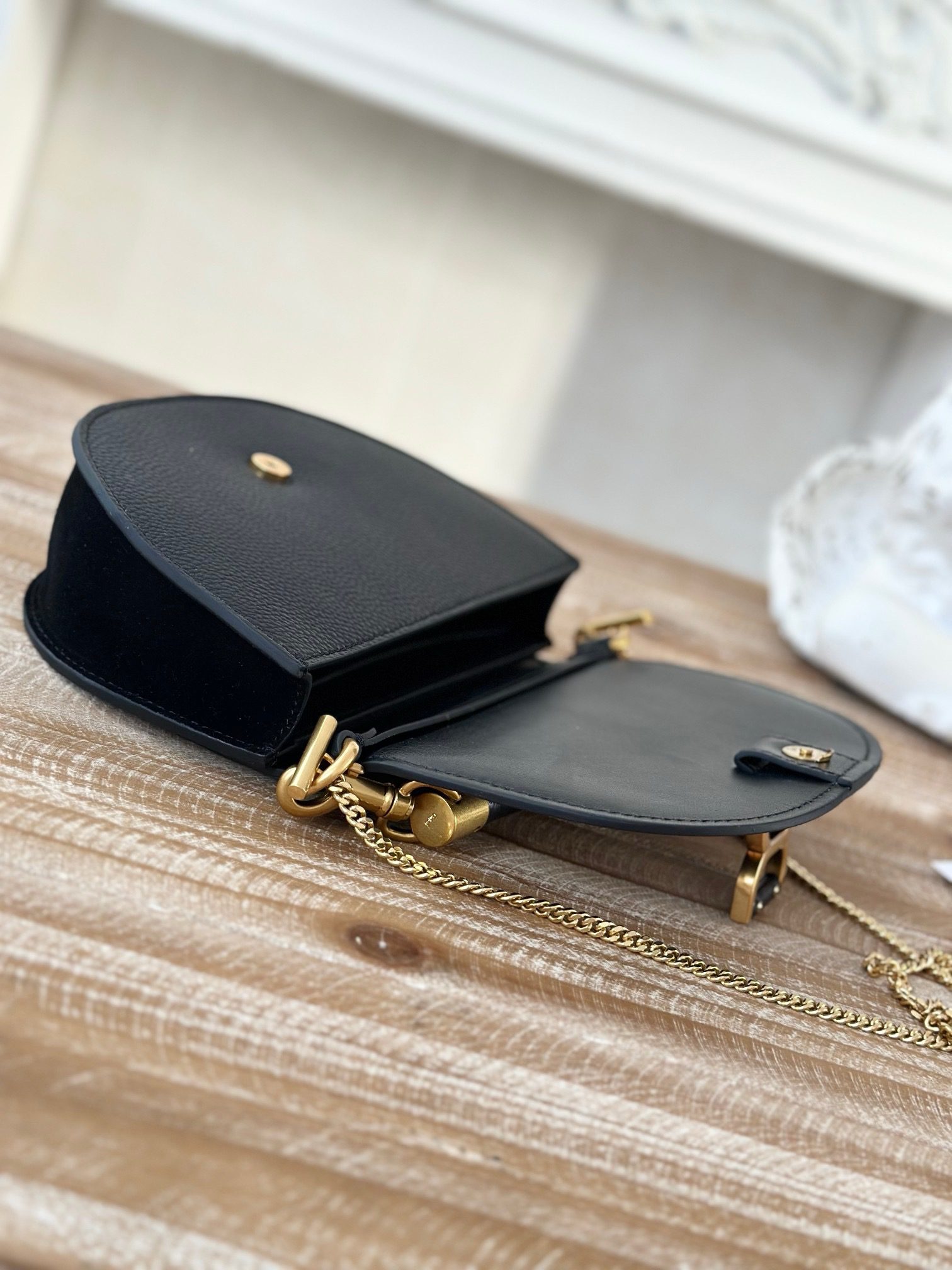 Marcie Chain Flap Bag. Authentic quality luxury bag crafted in genuine leather comes with authenticity card, dust bag and gift bag. Elevating Iconic Elegance: Marcie Line Redefined. Experience a fresh take on *loé's iconic Marcie line with this exquisite chain flap bag, meticulously crafted from a captivating blend of nappa lambskin, grained calfskin, and sumptuous suede. The line's signature hardware undergoes a graceful transformation, now adorned with *loé's engraved jewelry hallmark, adorning the flap with sophistication. An intricately hand-braided top handle pays homage to another hallmark Marcie feature, while a gracefully extended chain strap adds a refined touch. Whether you choose to drape it over your shoulder or wear it cross-body during the day, or opt to detach the strap and carry it by hand for a sophisticated evening ensemble, this flap bag is a versatile masterpiece. *loé's Marcie bag line effortlessly melds a feminine aesthetic with the free-spirited vibe of the '70s. An equestrian-inspired allure takes center stage, elevated by the allure of gleaming gold-toned hardware, resulting in a distinctly feminine yet timelessly chic look.