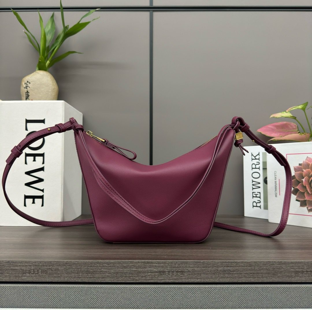 The Mini Hammock Hobo is a contemporary reimagining of *oewe’s iconic Hammock bag. This streamlined variation offers a sleek, sculptural silhouette designed as a versatile sling bag for modern living. Expertly crafted in classic calfskin, it features soft, supple leather and a compact form that adapts effortlessly to your day. The unique design allows for multiple carry options—wear it crossbody, over the shoulder, or by hand. Elegant yet functional, this mini hobo is perfect for essentials, making it an ideal choice for both daily wear and minimalist style statements.