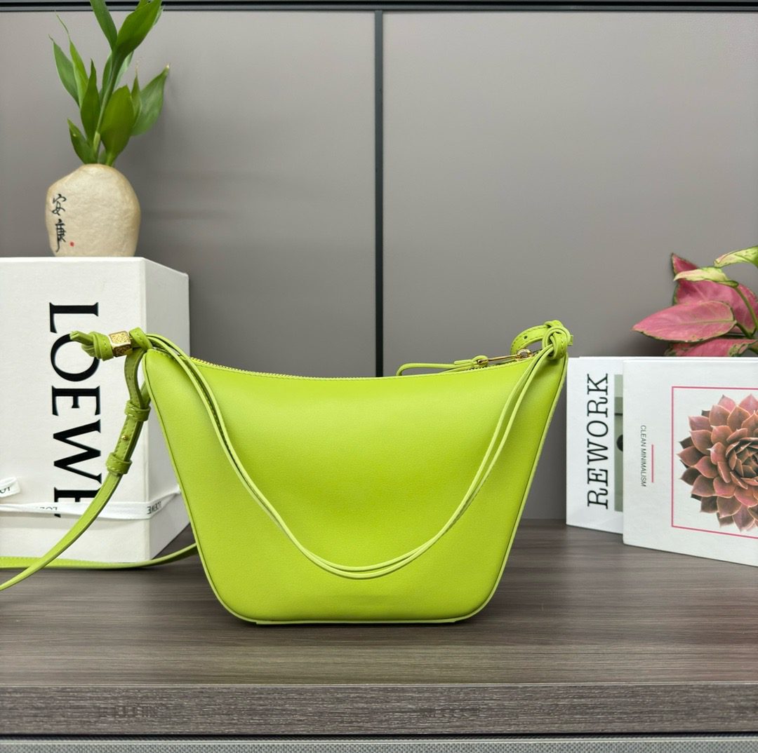 The Mini Hammock Hobo is a contemporary reimagining of *oewe’s iconic Hammock bag. This streamlined variation offers a sleek, sculptural silhouette designed as a versatile sling bag for modern living. Expertly crafted in classic calfskin, it features soft, supple leather and a compact form that adapts effortlessly to your day. The unique design allows for multiple carry options—wear it crossbody, over the shoulder, or by hand. Elegant yet functional, this mini hobo is perfect for essentials, making it an ideal choice for both daily wear and minimalist style statements.