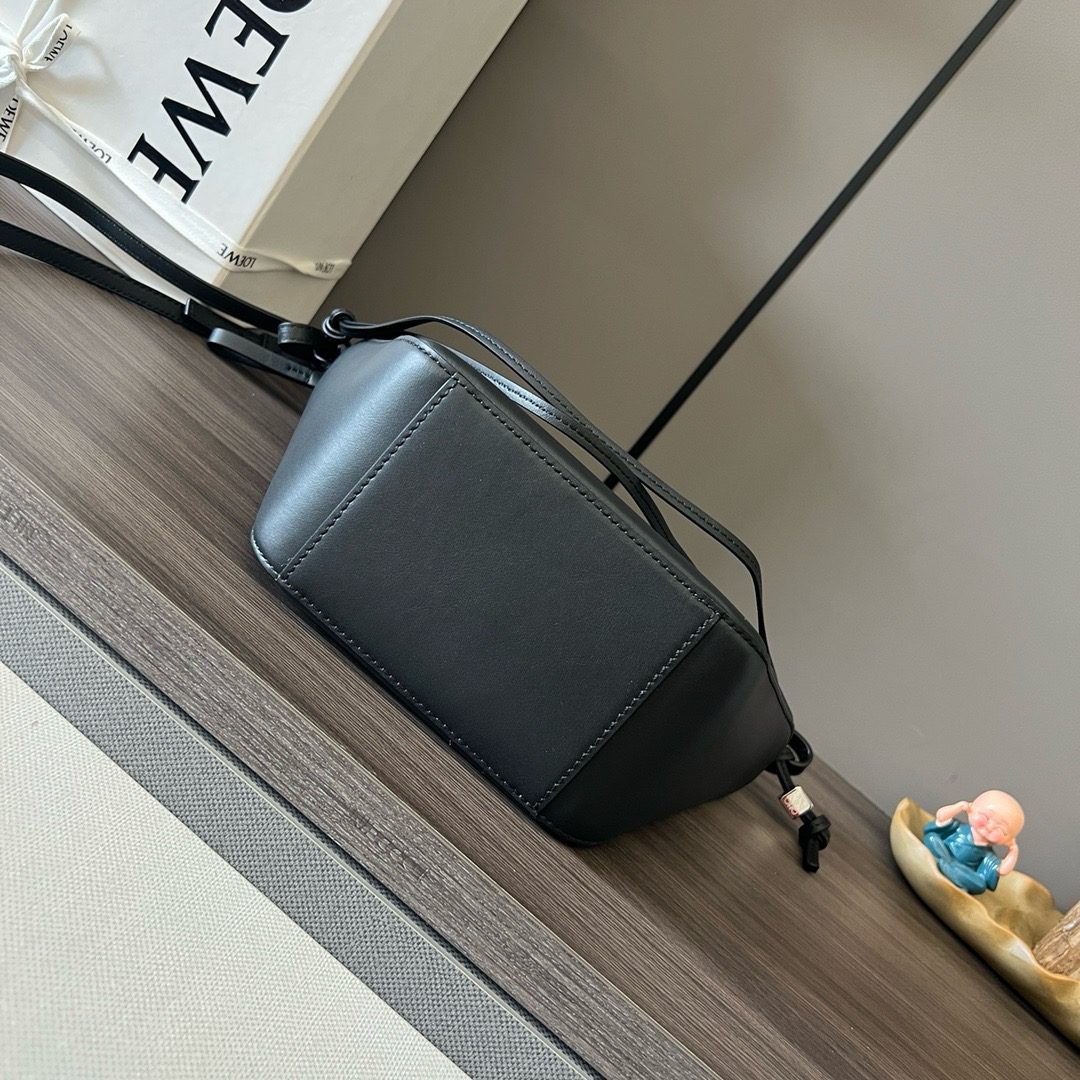 The Mini Hammock Hobo is a contemporary reimagining of *oewe’s iconic Hammock bag. This streamlined variation offers a sleek, sculptural silhouette designed as a versatile sling bag for modern living. Expertly crafted in classic calfskin, it features soft, supple leather and a compact form that adapts effortlessly to your day. The unique design allows for multiple carry options—wear it crossbody, over the shoulder, or by hand. Elegant yet functional, this mini hobo is perfect for essentials, making it an ideal choice for both daily wear and minimalist style statements.