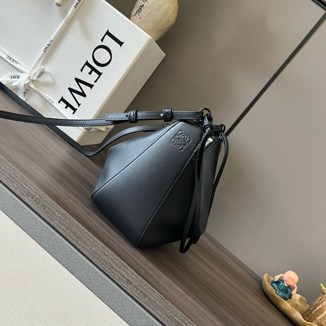 The Mini Hammock Hobo is a contemporary reimagining of *oewe’s iconic Hammock bag. This streamlined variation offers a sleek, sculptural silhouette designed as a versatile sling bag for modern living. Expertly crafted in classic calfskin, it features soft, supple leather and a compact form that adapts effortlessly to your day. The unique design allows for multiple carry options—wear it crossbody, over the shoulder, or by hand. Elegant yet functional, this mini hobo is perfect for essentials, making it an ideal choice for both daily wear and minimalist style statements.