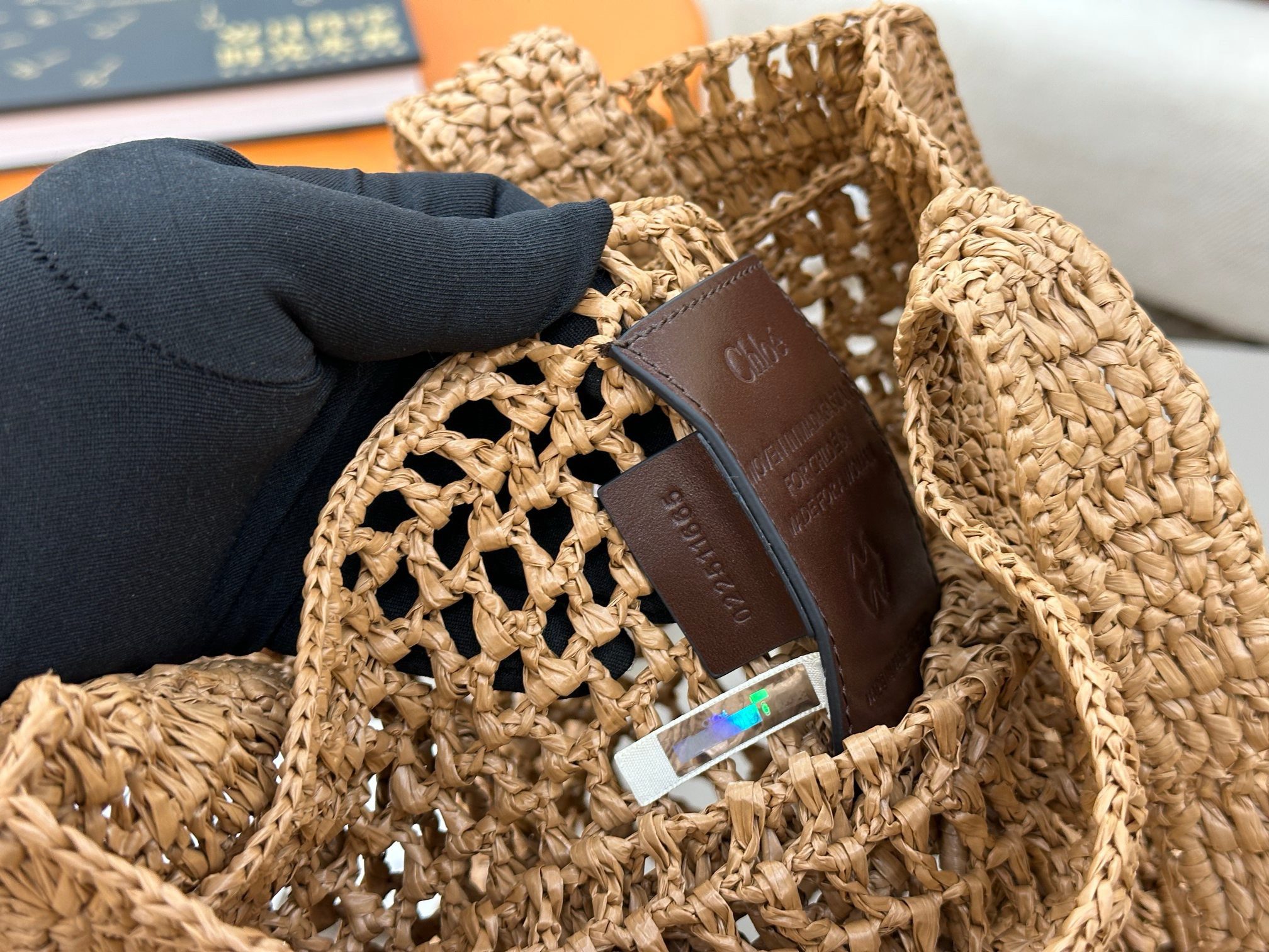 Summer Banana Tote Bag. Authentic quality luxury bag crafted in genuine leather comes with authenticity card, dust bag and gift bag. Heritage in Hand: Where Artisan Craft Meets Summer Elegance. Introducing the Summer Banana Tote—an artisanal masterpiece crafted from raffia and calfskin by a single artisan over 4.5 days in partnership with Made For A Woman. This spacious tote is adorned with a handwritten signature inspired by *loé’s rich heritage, while a playful dangling chain and delicate charms add the perfect finishing touch. A celebration of craftsmanship and effortless summer style.