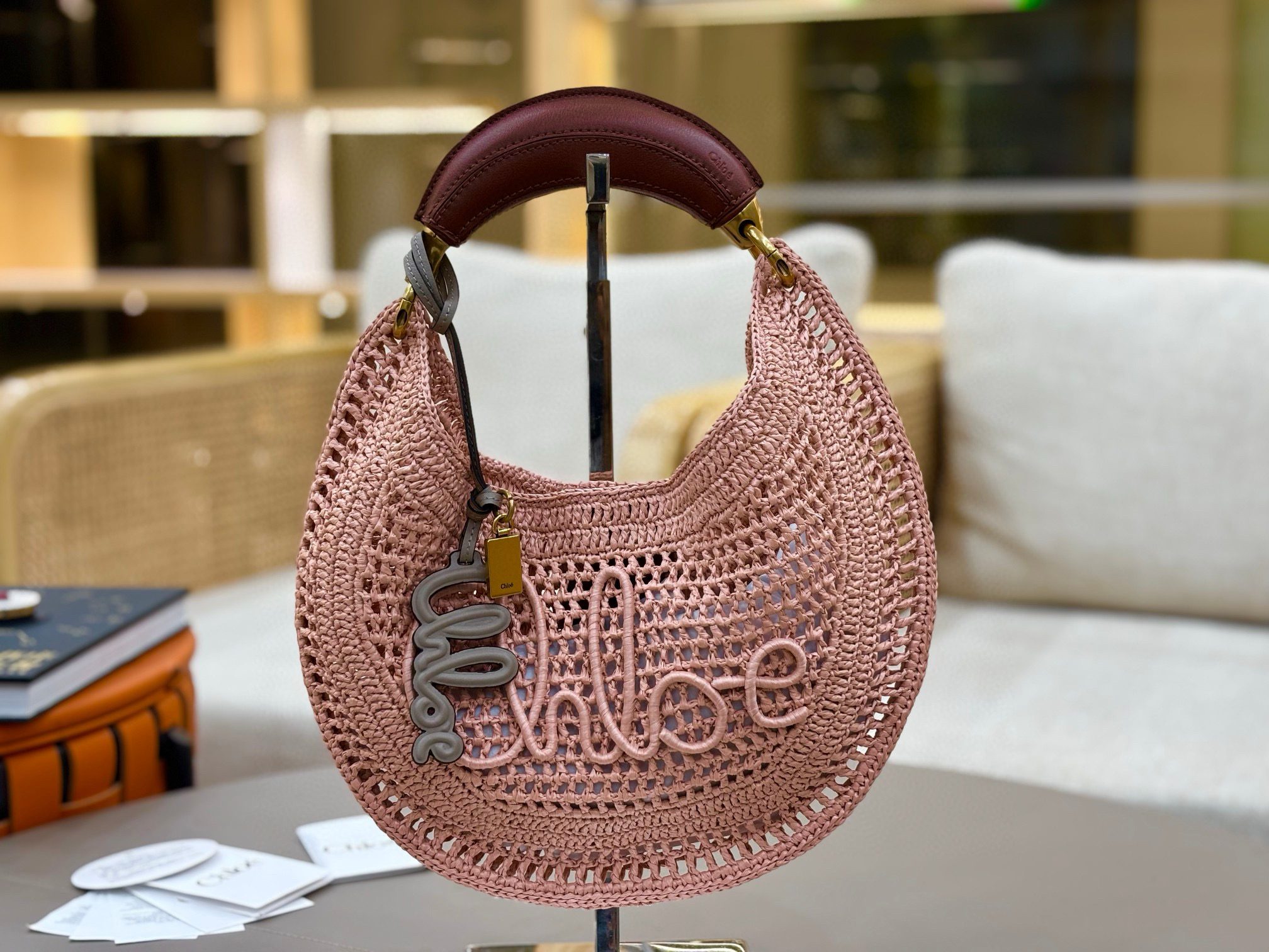 Summer Banana Hobo. Authentic quality luxury bag crafted in genuine leather comes with authenticity card, dust bag and gift bag. Artisanal Spirit, Curved in Style. Say hello to sunshine in bag form. The *LOÉ Summer Banana Hobo Bag is a joyful blend of craftsmanship and creativity, handwoven over four days by a single artisan in collaboration with Made For A Woman. This is not just a bag—it’s a story stitched in raffia and trimmed in luxurious calfskin. Its curved, banana-inspired silhouette hugs the shoulder with ease, while the sculptural handle and handwritten signature nod to *loé’s heritage of effortless elegance. Light, natural, and undeniably chic, it's the perfect companion for sun-soaked escapes or city strolls with a coastal state of mind. A celebration of craftsmanship, femininity, and the art of slow fashion.