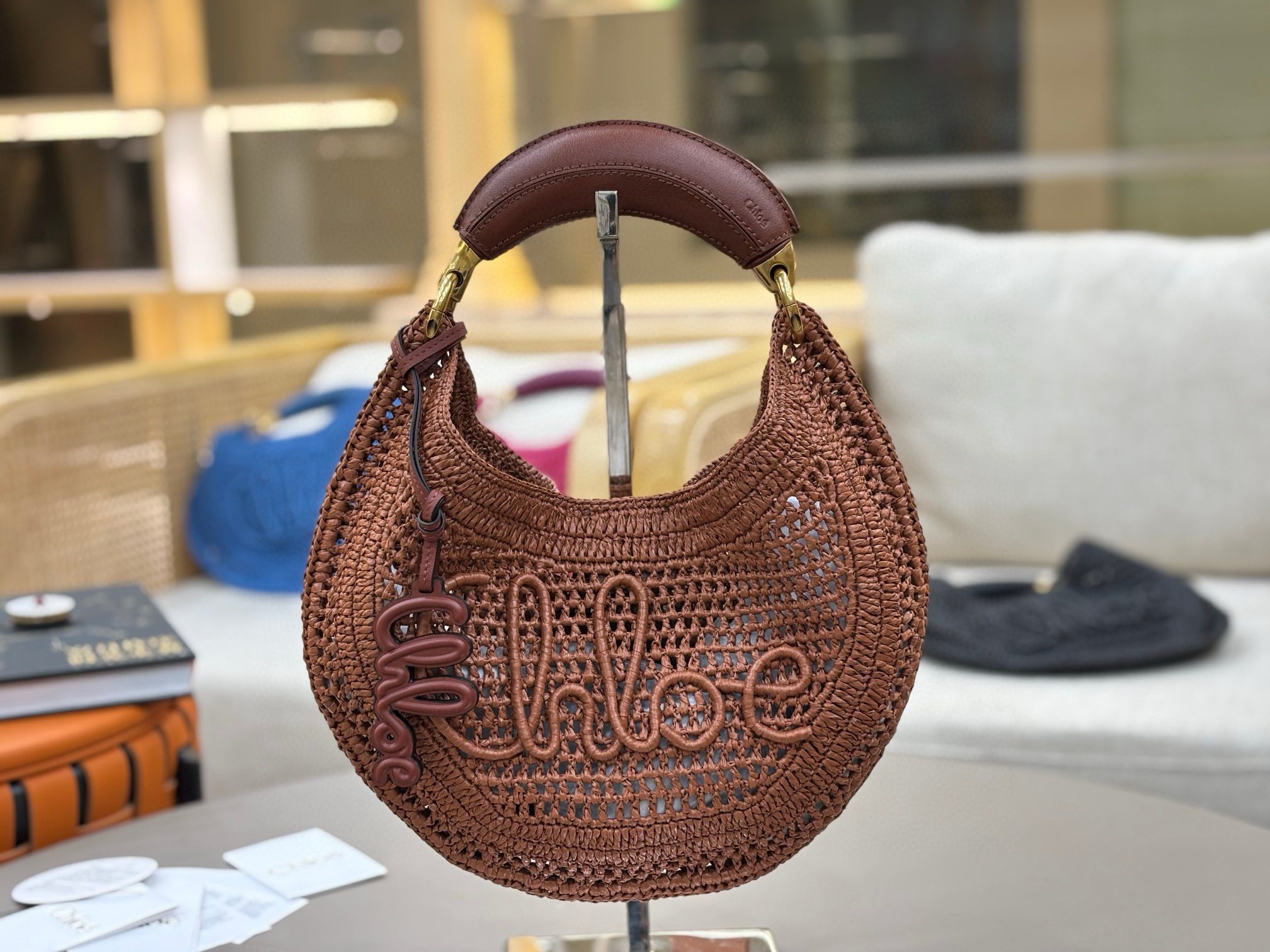 Summer Banana Hobo. Authentic quality luxury bag crafted in genuine leather comes with authenticity card, dust bag and gift bag. Artisanal Spirit, Curved in Style. Say hello to sunshine in bag form. The *LOÉ Summer Banana Hobo Bag is a joyful blend of craftsmanship and creativity, handwoven over four days by a single artisan in collaboration with Made For A Woman. This is not just a bag—it’s a story stitched in raffia and trimmed in luxurious calfskin. Its curved, banana-inspired silhouette hugs the shoulder with ease, while the sculptural handle and handwritten signature nod to *loé’s heritage of effortless elegance. Light, natural, and undeniably chic, it's the perfect companion for sun-soaked escapes or city strolls with a coastal state of mind. A celebration of craftsmanship, femininity, and the art of slow fashion.